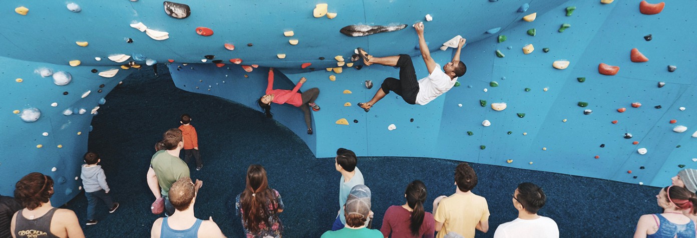 Rock climbing wall with rubber mulch surface